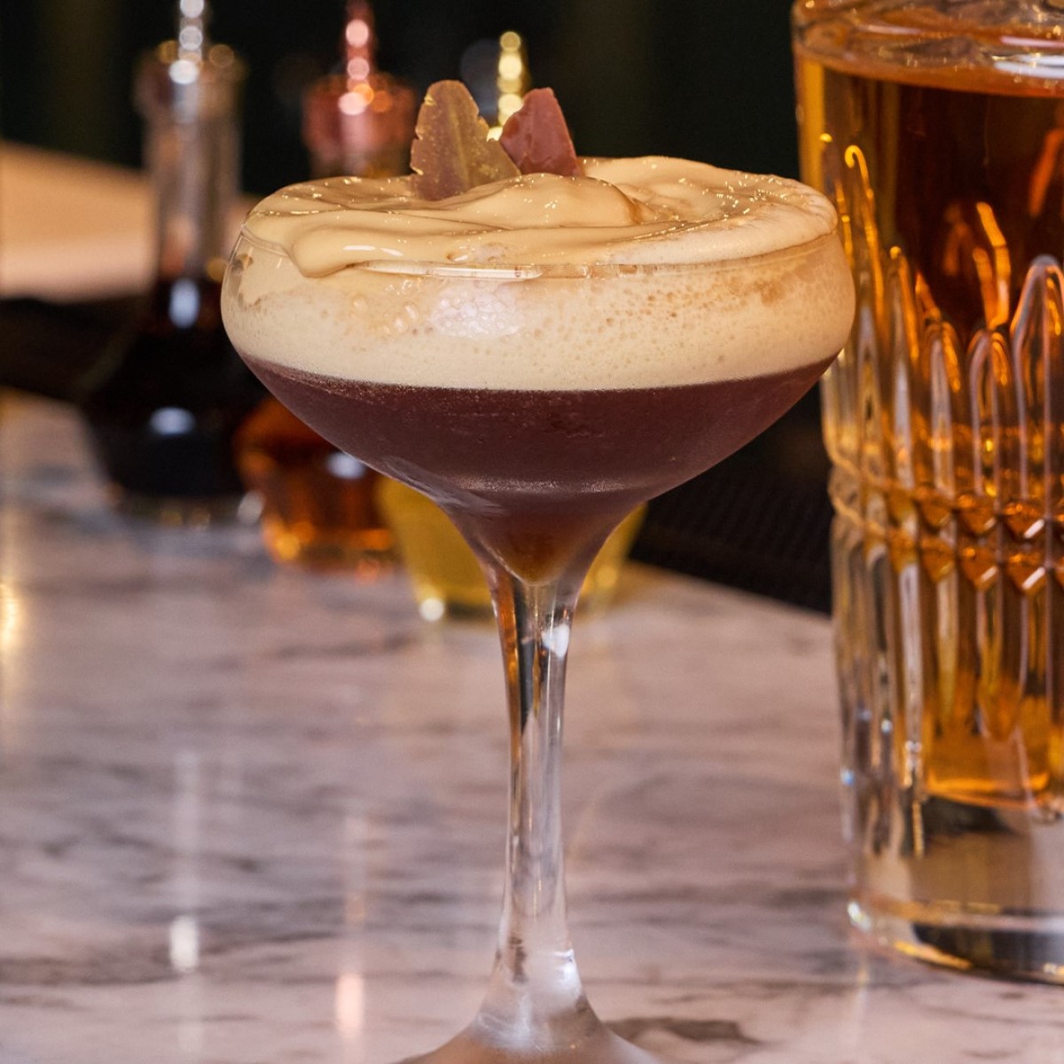 Factoria de Azucar's espresso martini with creamy topping and chocolate garnish.